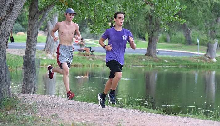 Sophomore Jehiah Rogers (left) and senior Nick Lodico run around the third lagoon at Dead Horse Ranch State Park during practice Friday afternoon. VVN/James Kelley