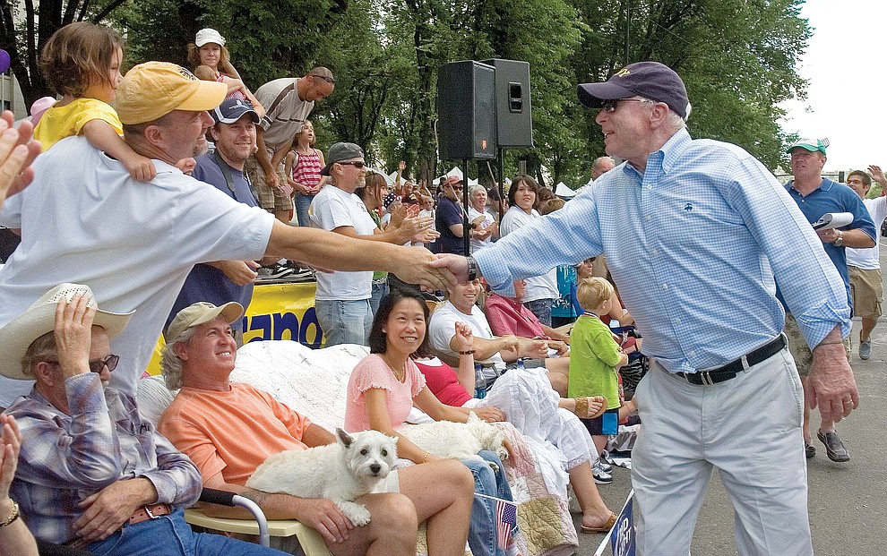 Prescott 07-04-09.Matt Hinshaw/The Daily Courier.Senior United States Arizona Senator John McCain shakes the hand of a bystander while walking down Whiskey Row Saturday morning during the Prescott Frontier Days Annual Parade..