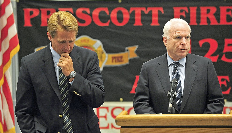 Prescott 07-05-13.Matt Hinshaw/The Daily Courier.Arizona Senator John McCain talks about meeting with the families of the Granite Mountain Hotshots while Senator Jeff Flake reacts Friday afternoon during a press conference at the Prescott High School cafeteria.