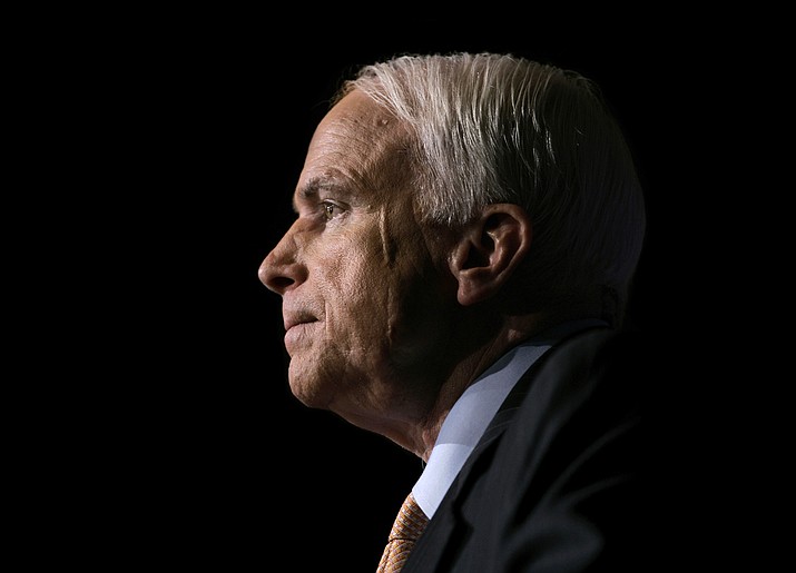 In this Nov. 16, 2006, file photo Sen. John McCain, R-Ariz., pauses while speaking to the GOPAC Fall Charter Meeting in Washington. McCain's family said in a statement on Aug. 24, 2018, the Arizona senator has chosen to discontinue medical treatment for brain cancer. The 81-year-old McCain has been away from the Capitol since December. McCain's face bears a scar from skin cancer surgery in 2000. (J. Scott Applewhite/AP, file)