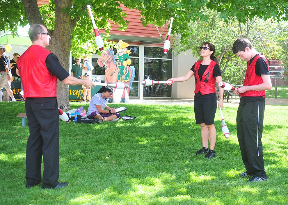 Neil Jordan, Heather Marriott and Ivan Marriott juggle as Yavapai College celebrates their 50th anniversary at the Prescott campus Saturday, August 25, 2018. (Les Stukenberg/Courier)