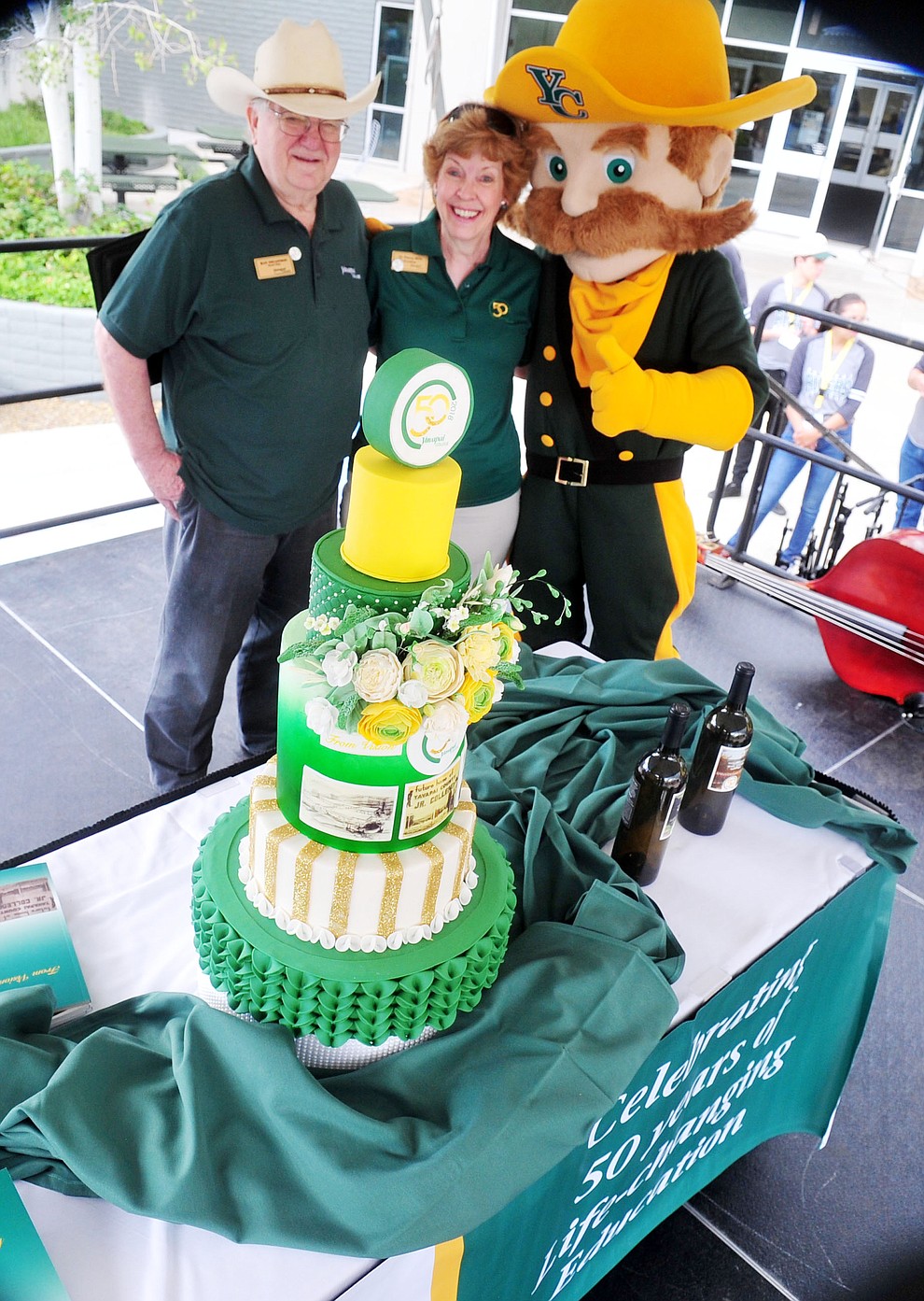 Board Chair Ray Sigafoos, President Penny Wills and the new mascot pose with the ceremonial cake as Yavapai College celebrates their 50th anniversary at the Prescott campus Saturday, August 25, 2018. (Les Stukenberg/Courier)