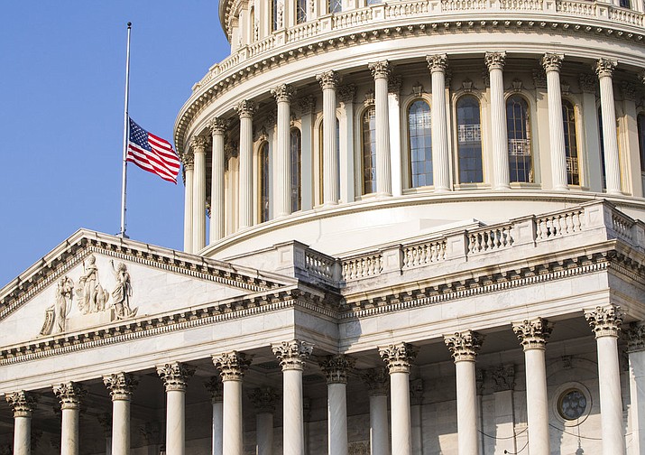 The American flag flies at half-staff at the Capitol in honor of Sen. John McCain of Arizona who died Saturday of brain cancer, in Washington, Monday, Aug. 27, 2018. McCain will lie in state in the Capitol Rotunda on Friday. (AP Photo/J. Scott Applewhite)
