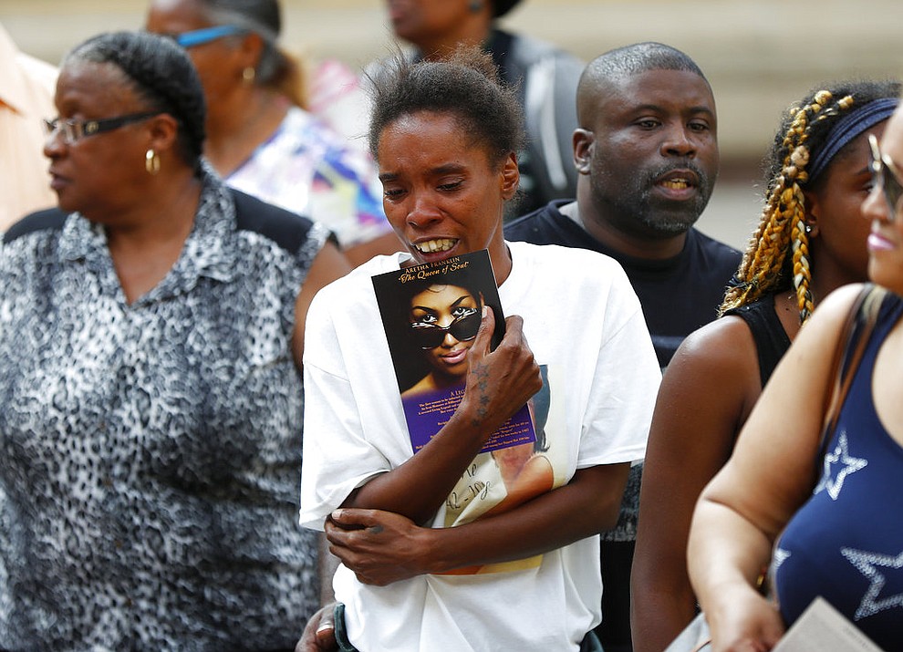 A member of the public becomes emotional viewing Aretha Franklin's coffin at Charles H. Wright Museum of African American History during a public visitation in Detroit, Tuesday, Aug. 28, 2018. Franklin died Aug. 16, of pancreatic cancer at the age of 76. (AP Photo/Paul Sancya, Pool)