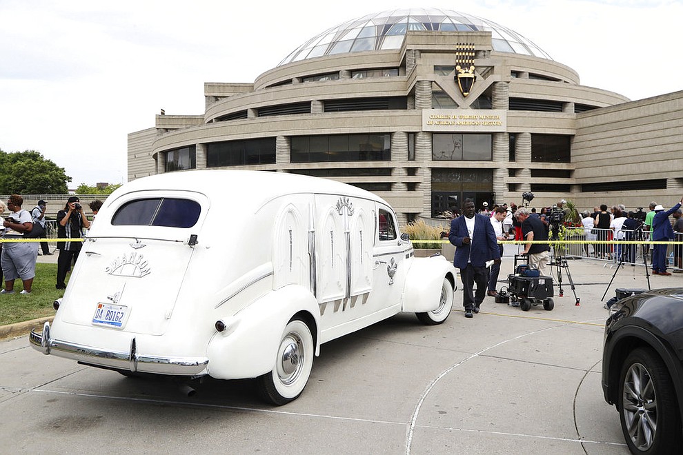 Swanson Funeral Home's 1936 LaSalle hearse is parked outside the Charles H. Wright Museum of African American History, Tuesday, Aug. 28, 2018, in Detroit. The hearse transported the gold casket of Aretha Franklin to the museum where she will lay in state for two days. (AP Photo/Carlos Osorio)