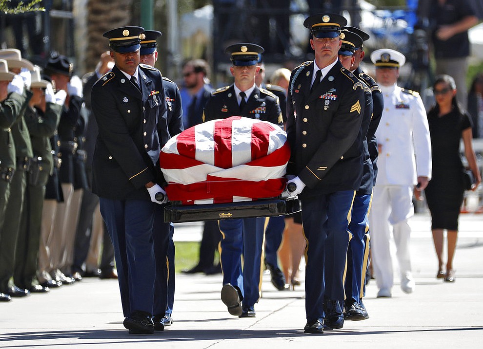 Military personal carry the casket of Sen. John McCain, R-Ariz., into the Capitol rotunda for a memorial service, Wednesday, Aug. 29, 2018, at the Capitol in Phoenix. (AP Photo/Matt York)