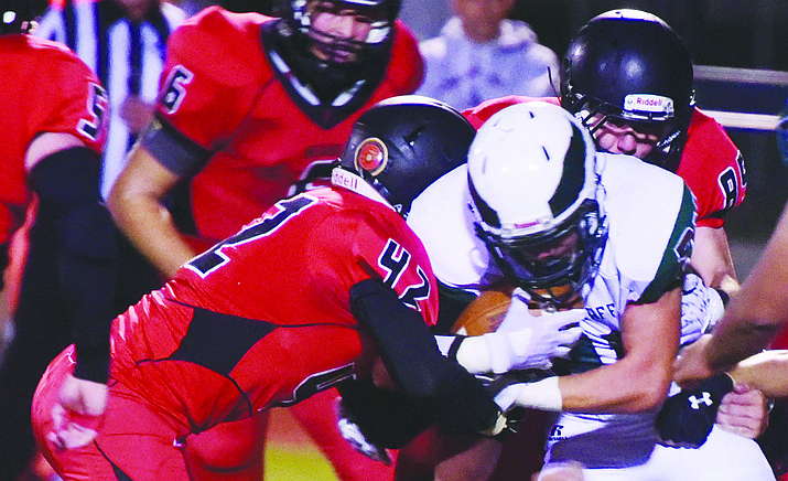 In this Sept. 22, 2017, file photo, Bradshaw Mountain linebacker Noah Shaver moves in for a tackle against Grand Canyon region opponent Flagstaff at Bob Pavlich Field in Prescott Valley. If you look closely, you will see a circular Marine Corps emblem on the back of Shaver’s helmet. It was part of the Bears team’s tribute to military veterans in 2017. (Courier, file)