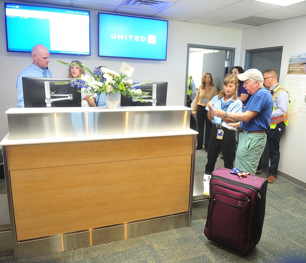 Gail Yungman helps Jeff Plotkin with flight information as United Express officially opened for business at the Prescott Regional Airport  Wednesday, August 29, 2018. (Les Stukenberg/Courier)