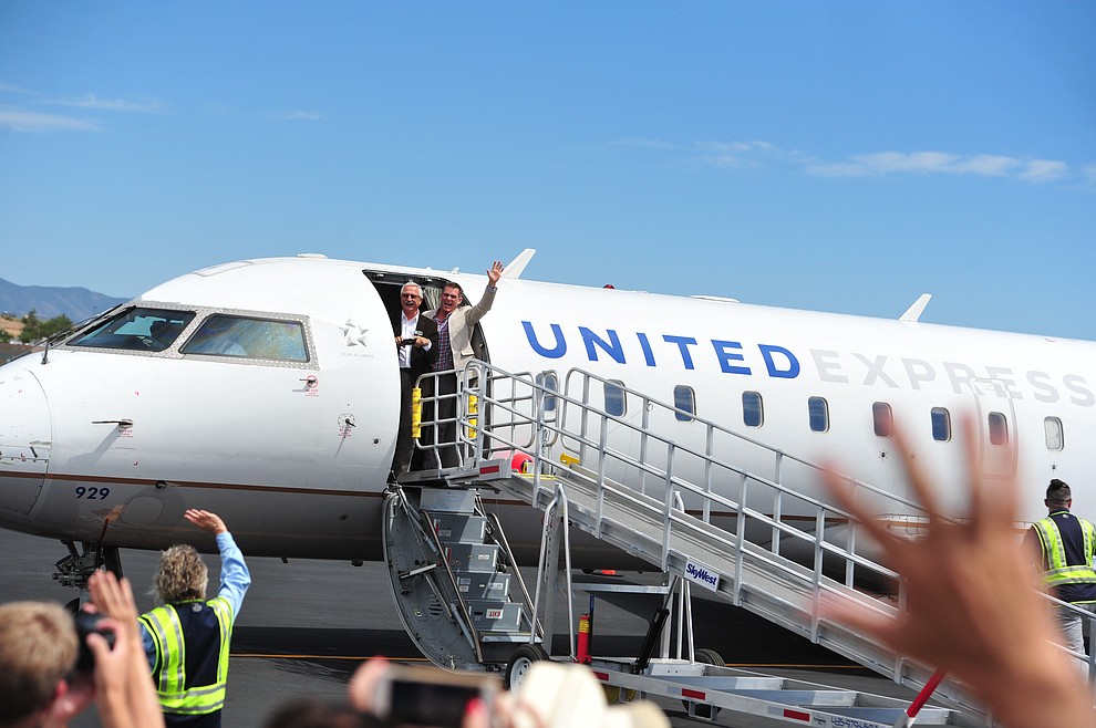 Prescott City Councilman Steve Sischka and Mayor Greg Mengarelli wave after arriving as United Express officially opened for business at the Prescott Regional Airport  Wednesday, August 29, 2018. (Les Stukenberg/Courier)