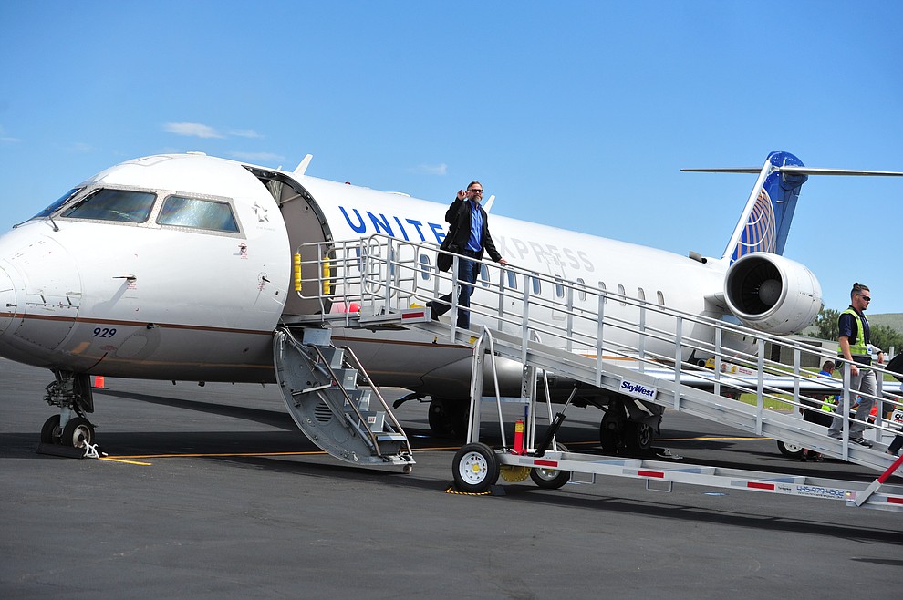 Prescott City Manager Michael Lamar deplanes as United Express officially opened for business at the Prescott Regional Airport  Wednesday, August 29, 2018. (Les Stukenberg/Courier)