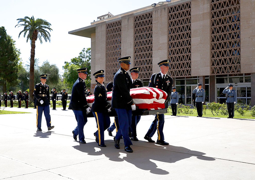 Members of the Arizona National Guard  carry the casket of Sen. John McCain, R-Ariz., into the Capitol rotunda for a memorial service, Wednesday, Aug. 29, 2018, at the Capitol in Phoenix. (AP Photo/Matt York)