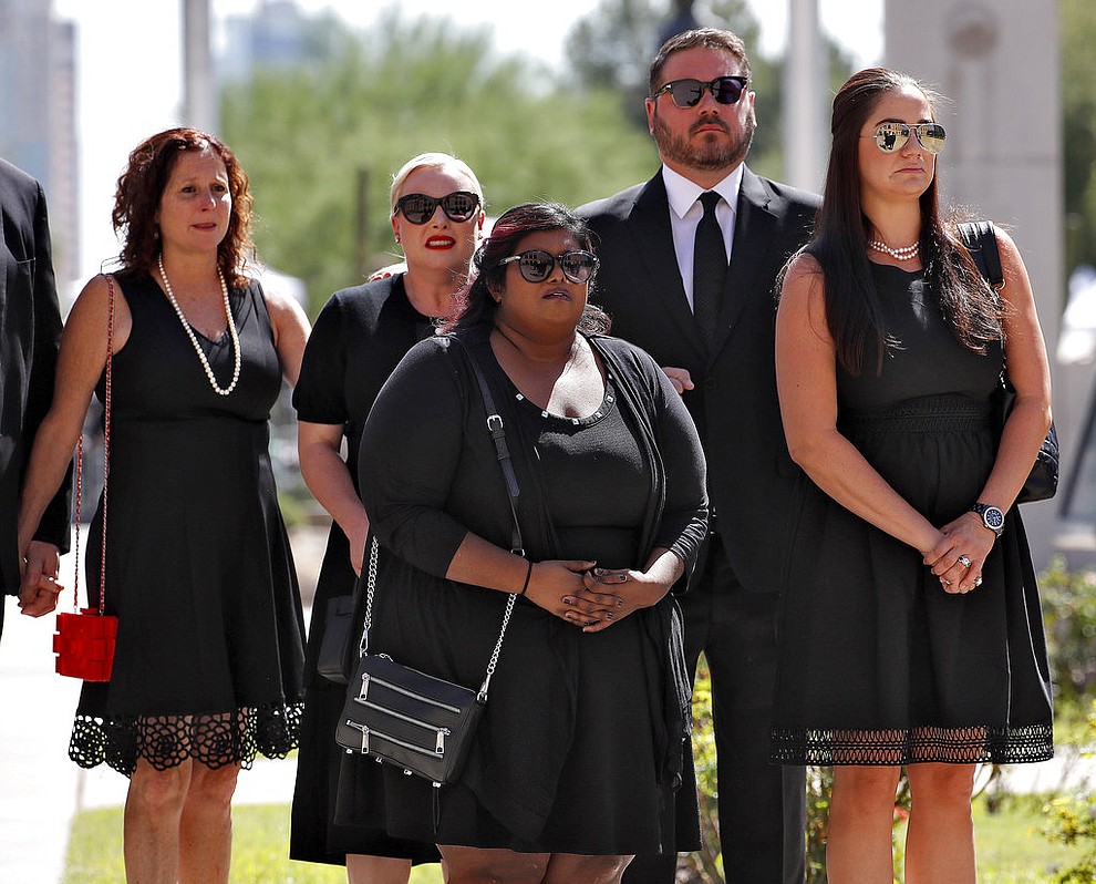 Children of Sen. John McCain, R-Ariz., from back left Sidney McCain, Meghan McCain and her husband Ben Domenech, Bridgett McCain, front center and daughter-n-law Holly McCain, follow behind the casket into the Capitol rotunda for a memorial service, Wednesday, Aug. 29, 2018, at the Capitol in Phoenix. (AP Photo/Matt York)
