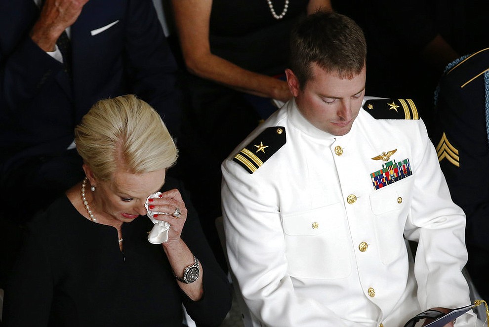 Cindy McCain, wife of Sen. John McCain, R-Ariz., wipes a tear away next to her son Jack during a memorial service at the Arizona Capitol on Wednesday, Aug. 29, 2018, in Phoenix. (AP Photo/Ross D. Franklin, Pool)