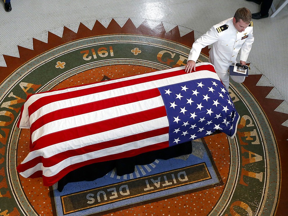 Jack McCain, son of, Sen. John McCain, R-Ariz. touches the casket during a memorial service at the Arizona Capitol on Wednesday, Aug. 29, 2018, in Phoenix. (AP Photo/Ross D. Franklin, Pool)