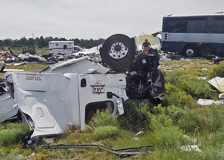 This photo provided by Chris Jones shows first responders working the scene of a collision between a Greyhound passenger bus and a semi-truck on Interstate 40 near the town of Thoreau, N.M., near the Arizona border, Thursday, Aug. 30, 2018. Multiple people were killed and others were seriously injured. Officers and rescue workers were on scene but did not provide details about how many people were killed or injured, or what caused the crash. (Chris Jones via AP)