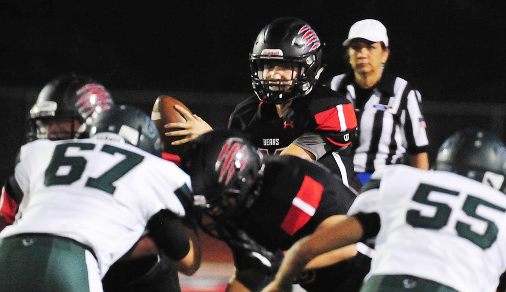 Bradshaw Mountain's Austin Gonzales (13) takes the snap as the Bears take on the Youngker Roughriders in their home opener Friday, August 31, 2018 in Prescott Valley. (Les Stukenberg/Courier)
