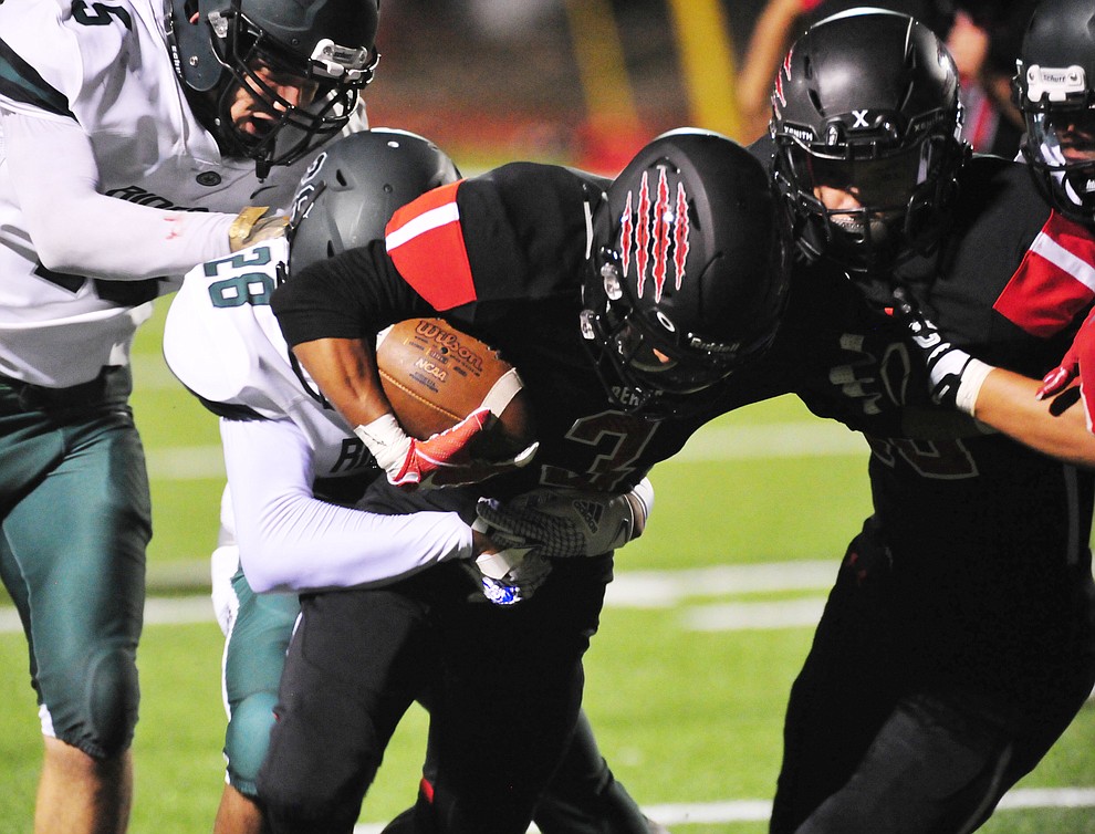 Bradshaw Mountain's Ruben Gonzalez (3) battles for extra yards as the Bears take on the Youngker Roughriders in their home opener Friday, August 31, 2018 in Prescott Valley. (Les Stukenberg/Courier)