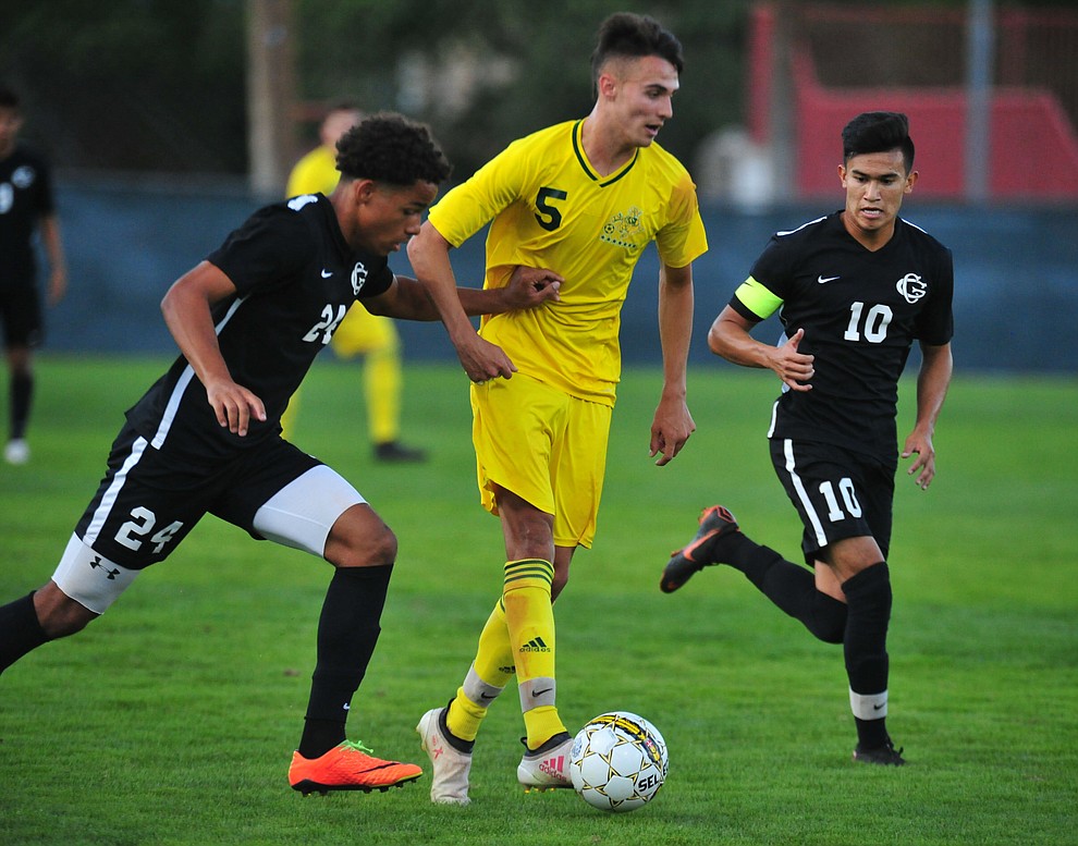 Yavapai's Gabriel Claudio splits a pair of defenders as the Roughriders take on Chandler/Gilbert in their home opener Saturday Sept. 1, 2018 in Prescott. (Les Stukenberg/Courier)