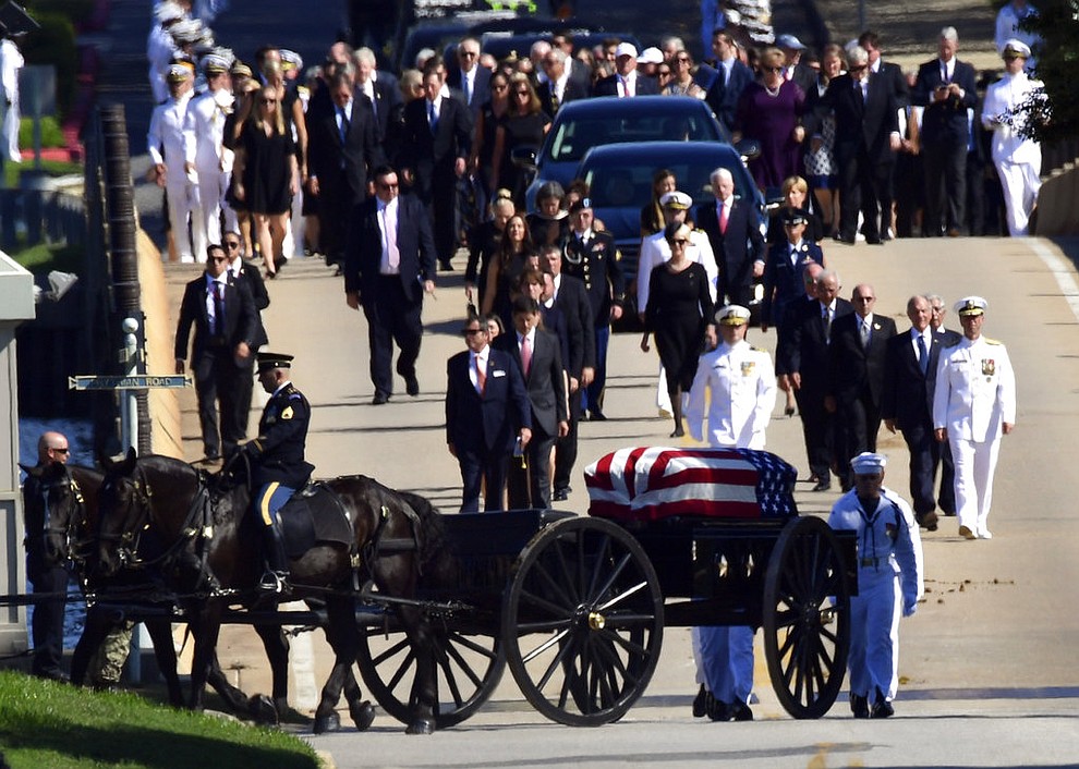 Family members, including Cindy McCain, back center, follow a horse-drawn caisson that carries the casket of Sen. John McCain, R-Ariz., as it proceeds to the United States Naval Academy cemetery in Annapolis, Md., Sunday, Sept. 2, 2018, for burial. McCain died Aug. 25 from brain cancer at age 81. (AP Photo/Susan Walsh)