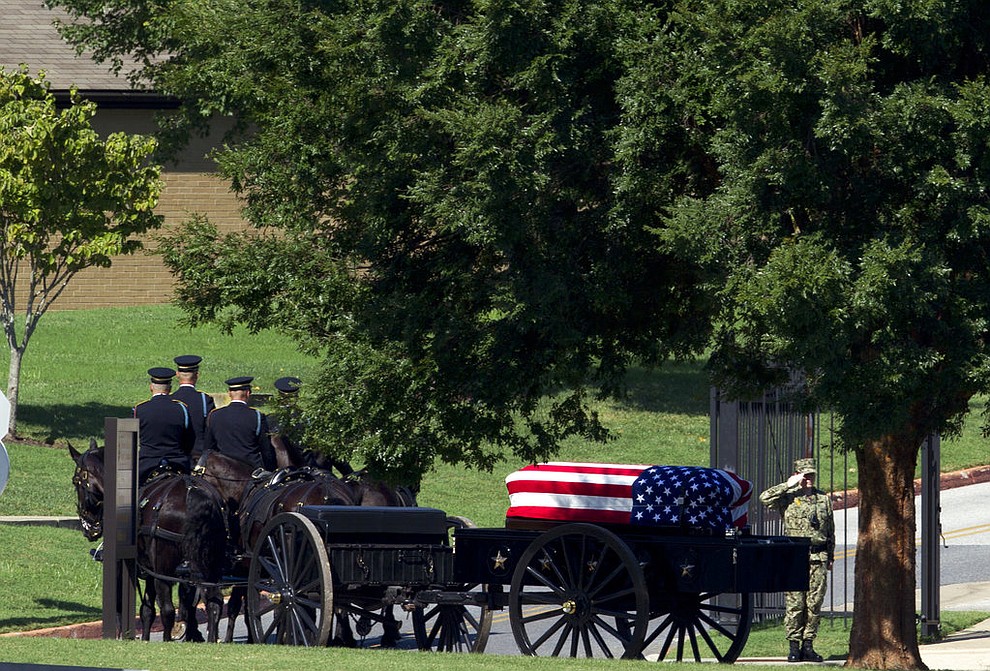 A horse drawn caisson carries the casket containing the remains of Sen. John McCain, R-Ariz., to his burial sight at the United States Naval Academy Cemetery in Annapolis Md., Sunday, Sept. 2, 2018. McCain died Aug. 25 from brain cancer at age 81. (AP Photo/Jose Luis Magana)