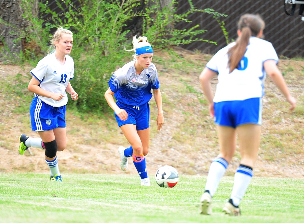 Chino Valley's Lauren Foster splits a pair of defenders as the Cougars take on Snowflake at home Tuesday Sept. 4, 2018. (Les Stukenberg/Courier)