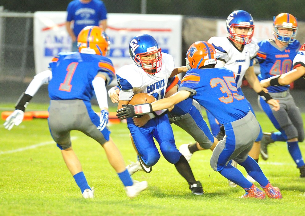 Chino Valley's Dante DeBono and Collin Knight box in a runner as they host Camp Verde in the annual Copper Boot game Friday Sept. 7, 2018 in Chino Valley. (Les Stukenberg/Courier)