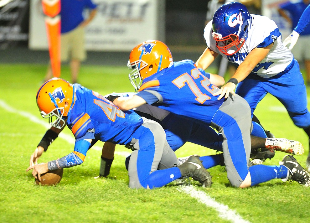 Chino Valley's Ty Bassett recovers a fumble as they host Camp Verde in the annual Copper Boot game Friday Sept. 7, 2018 in Chino Valley. (Les Stukenberg/Courier)