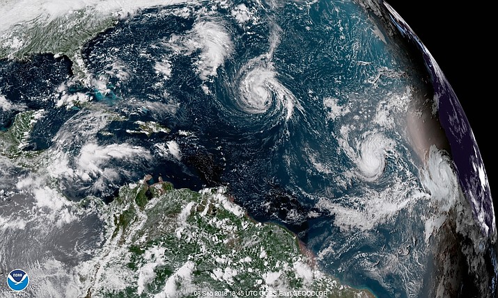 This enhanced satellite image shows Tropical Storm Florence, center, in the Atlantic Ocean on Saturday, Sept. 8, 2018 at 2:45 p.m. EDT. (NOAA via AP)

