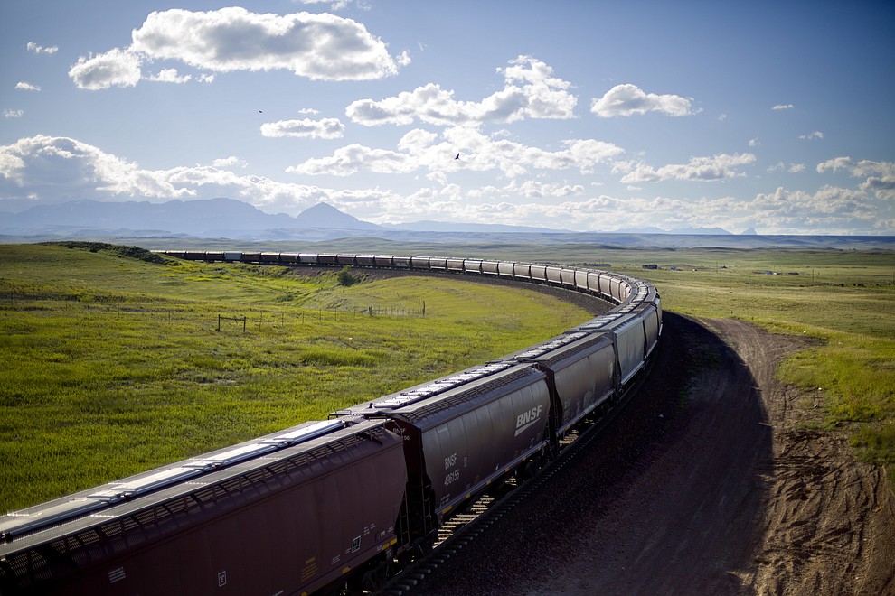 A train rounds a bend while traveling across the landscape of the Blackfeet Indian Reservation in Browning, Mont., Tuesday, July 10, 2018. Tribal police and investigators from the federal Bureau of Indian Affairs serve as law enforcement on reservations, which are sovereign nations. But the FBI and U.S. Department of Justice investigate certain offenses and, if there's ample evidence, prosecute major felonies such as murder, kidnapping and rape if they happen on tribal lands. (AP Photo/David Goldman)