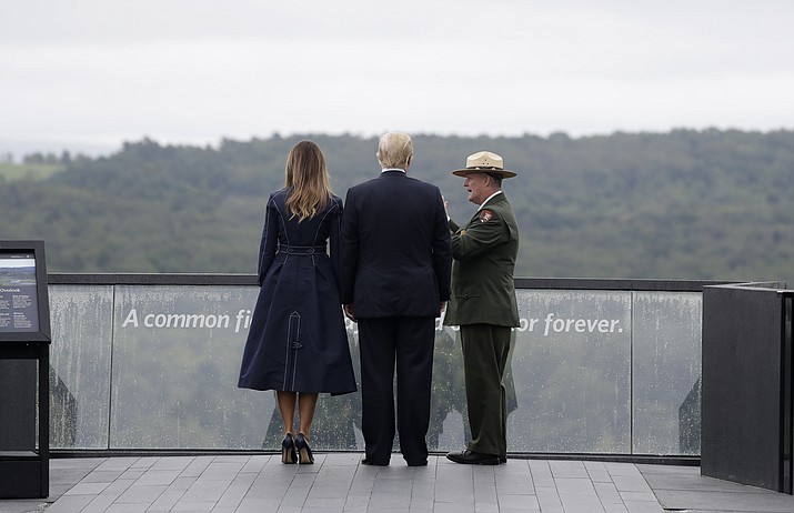 President Donald Trump and first lady Melania Trump, escorted by Stephen Clark, Superintendent of the National Parks of Western Pennsylvania, walk along the September 11th Flight 93 memorial, Tuesday, Sept. 11, 2018, in Shanksville, Pa., escorted by (AP Photo/Evan Vucci)