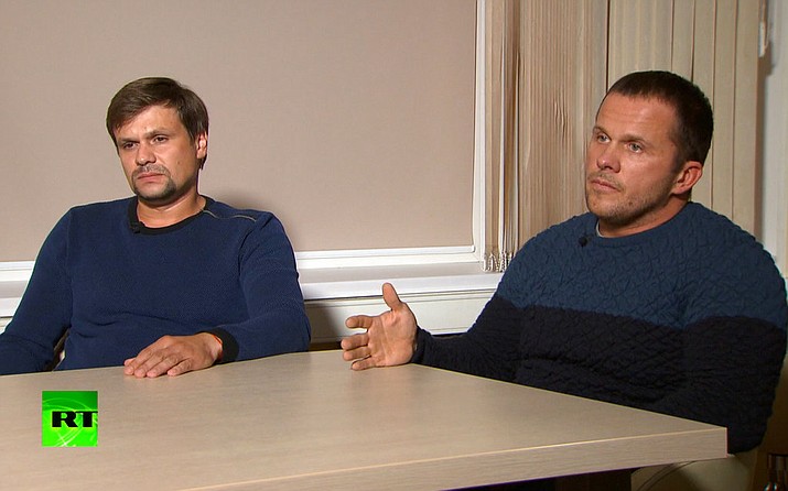 In this video grab provided by the RT channel , Ruslan Boshirov, left, and Alexander Petrov attend their first public appearance in an interview with the Kremlin-funded RT channel in Moscow, Russia, Thursday, Sept. 13, 2018. The two Russian men charged in Britain with poisoning a former Russian spy with a deadly nerve agent appeared on Russian television on Thursday, saying they visited the suspected crime scene as tourists. (RT channel video via AP)