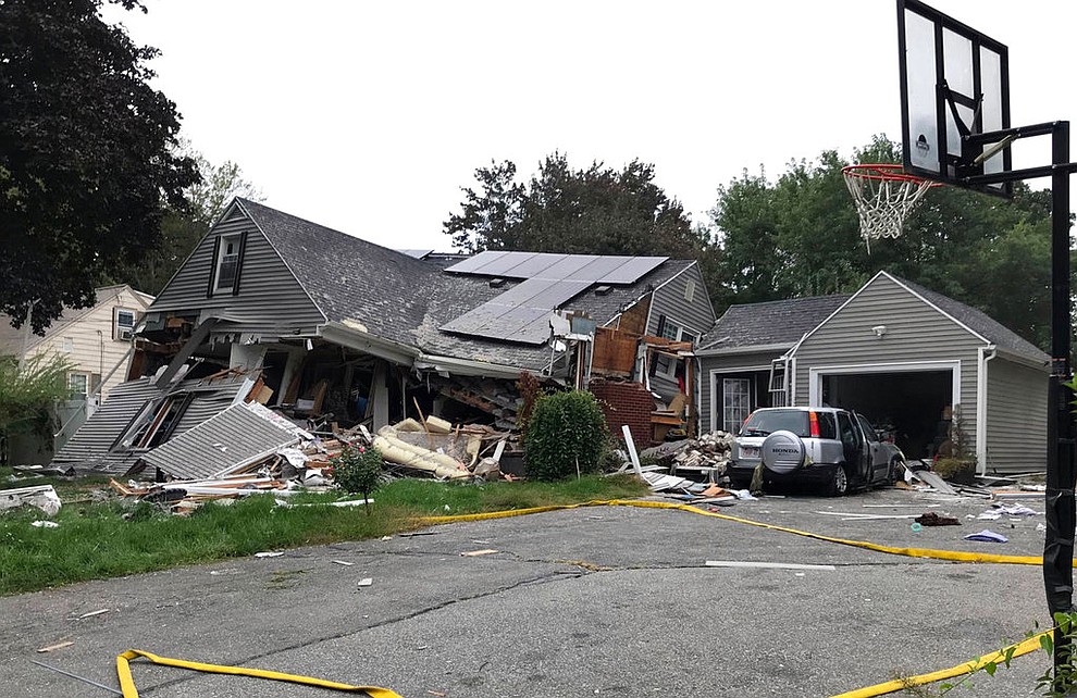 A house is destroyed in Lawrence, Mass., Thursday, Sept. 13, 2018 after a series of gas explosions in the area. First-responders continued to fight at least 50 fires in Lawrence, Andover and North Andover Mass., Thursday. The fires are being attributed to problems with the natural gas system and officials are urging residents to leave their homes if they smell gas. (Carl Russo/The Eagle-Tribune via AP)