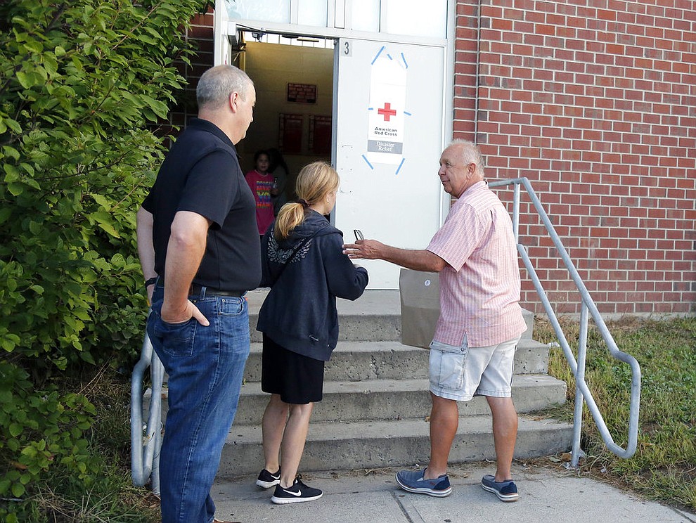 Michael Smolak, of Smolak Farms in North Andover, delivers a bag of baked goods to the emergency shelter set up at North Andover High School of Friday, Sept 14, 2018. Many residents were forced to evacuate their homes Thursday afternoon after gas explosions and fires triggered by a problem with a gas line that feeds homes in several communities north of Boston (AP Photo/Mary Schwalm)