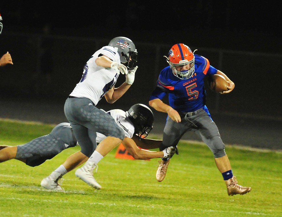 Chino Valley's Mikey Paulus breaks a tackle as the Cougars host Arizona College Prep Friday, Sept. 14, 2018. (Les Stukenberg/Courier)