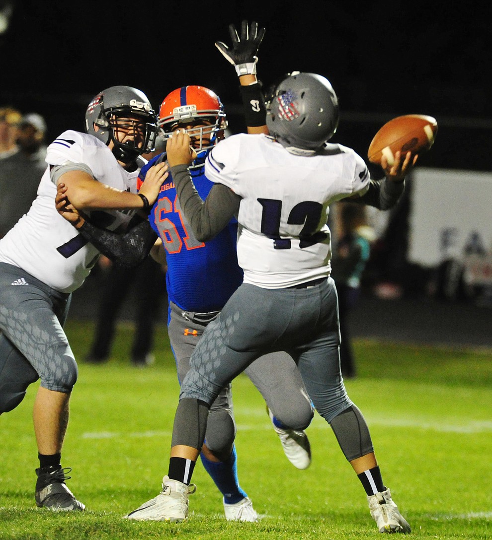 Chino Valley's Rudy Melendez puts pressure on the quarterback as the Cougars host Arizona College Prep Friday, Sept. 14, 2018. (Les Stukenberg/Courier)
