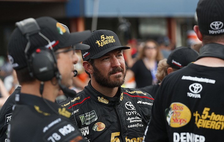 In this Aug. 10, 2018, file photo, Martin Truex Jr. watches times during qualifications for a NASCAR Cup Series auto race at Michigan International Speedway in Brooklyn, Mich. Truex begins his quest to repeat as NASCAR’s champion at the playoff opener this weekend in Vegas. (Paul Sancya/AP, file)