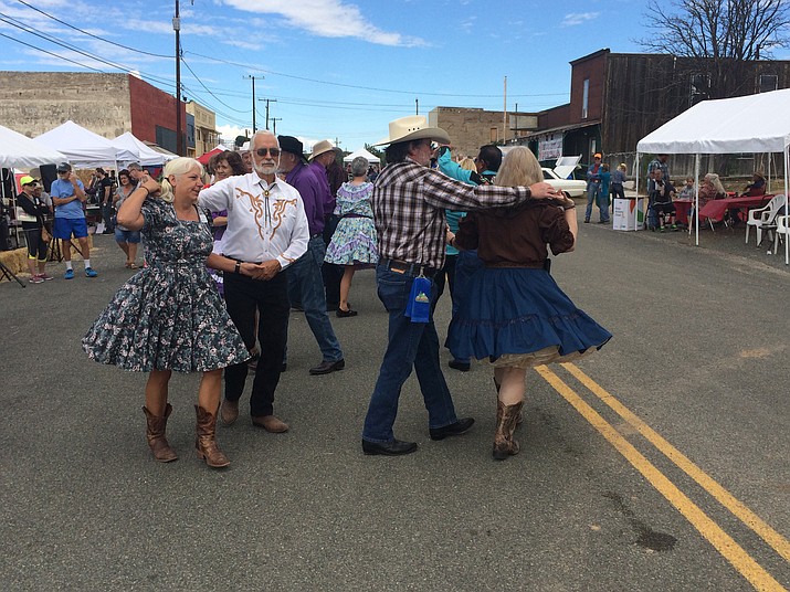 Gerry and Kimn Cook participate in a square dance during the 109th annual Agua Fria Festival. (Jason Wheeler/Tribune file)