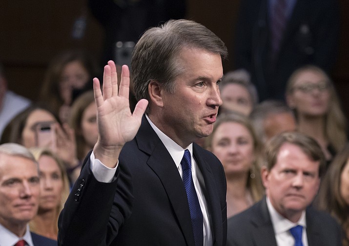 In this Sept. 4, 2018, file photo, President Donald Trump's Supreme Court nominee Brett Kavanaugh is sworn in before the Senate Judiciary Committee on Capitol Hill in Washington. Both parties are grappling with tremendous political risks in the midst of an increasingly messy Supreme Court fight. Republicans risked alienating women, particularly in the nation’s suburbs, by embracing President Trump’s hand-picked nominee even after allegations surfaced of decades-old sexual misconduct. Democrats, who want to delay the high-stakes nomination, risked energizing complacent Republican voters should they play politics with the sensitive allegations.(J. Scott Applewhite/AP, File)

