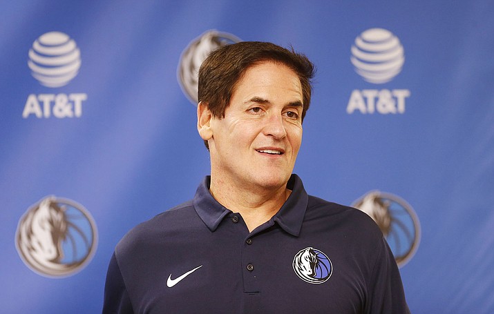 Dallas Mavericks owner Mark Cuban stands on stage in February before an NBA basketball press conference in Dallas. Cuban has agreed to contribute $10 million to women’s causes and domestic violence awareness as part of the NBA’s investigation into workplace conditions with his franchise. (Ron Jenkins/AP, File)
