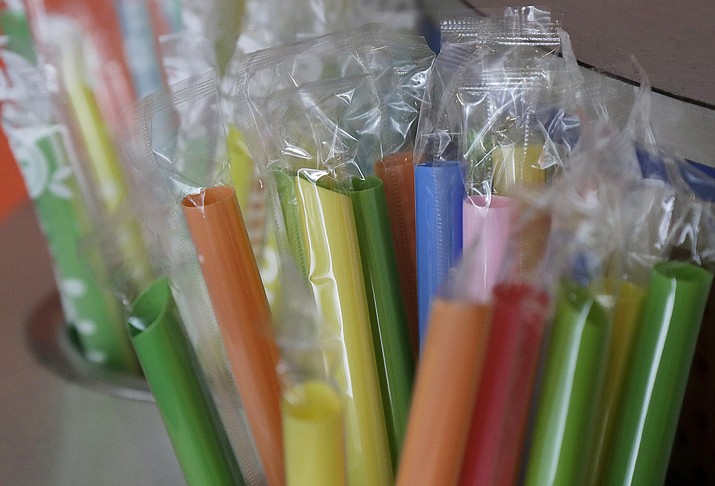 This July 17, 2018, file photo shows wrapped plastic straws at a bubble tea cafe in San Francisco. A law signed Thursday, Sept. 20, 2018, by Gov. Jerry Brown makes California the first state to bar full-service restaurants from automatically giving out single-use plastic straws. It takes effect next year. (Jeff Chiu/AP, File)