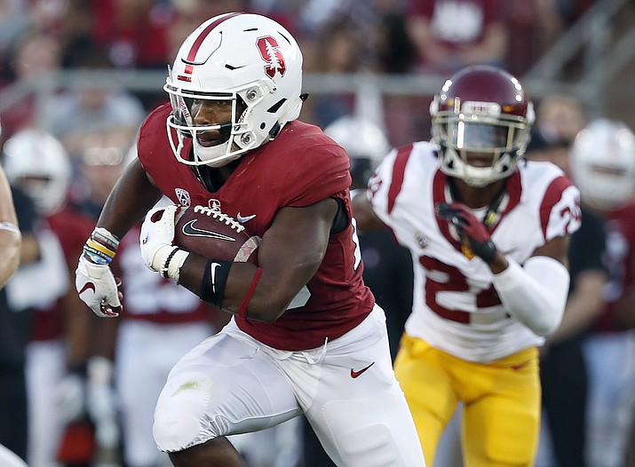 In this Saturday, Sept. 8, 2018, file photo, Stanford running back Bryce Love (20) rushes against Southern California during the first half of an NCAA college football game in Stanford, Calif. A couple of Pac-12 stars have a chance to put themselves into the Heisman mix on Saturday night when No. 7 Stanford visits No. 20 Oregon. Love, last year’s Heisman runner-up behind Sooners quarterback Baker Mayfield, is already way behind the field in the Heisman race, but the speedster can make up ground in a nationally televised night game. (Tony Avelar/AP, file)
