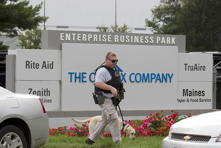ATF police officer with a sniffing dog walks out the industrial complex in Harford County, Md., Thursday, Sept. 20, 2018. Authorities say multiple people have been shot in northeast Maryland in what the FBI is describing as an "active shooter situation." (AP Photo/Jose Luis Magana)