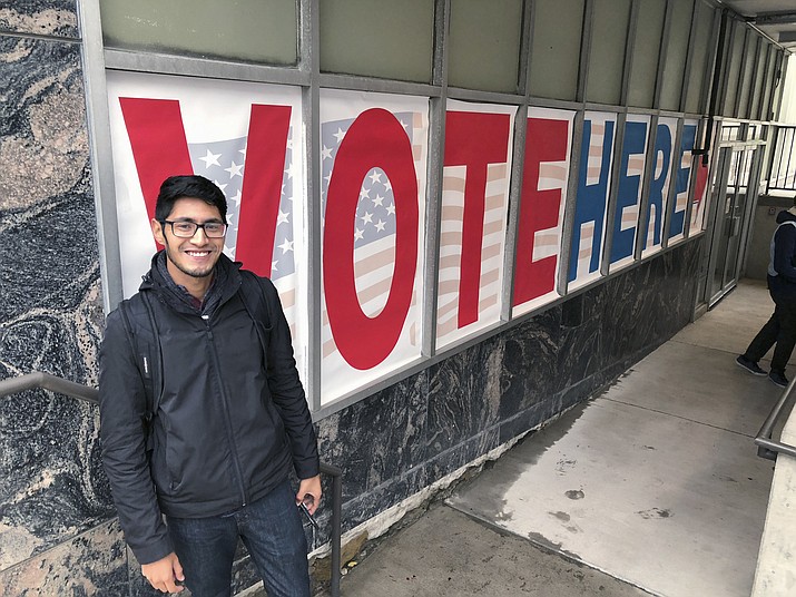 Minnesota Democratic-Farmer-Labor Party activist Manilan Houle, of Minneapolis, is the first person waiting in line outside a polling station in downtown Minneapolis on Friday, Sept. 21, 2018, on the first day of early voting in Minnesota in the 2018 midterm elections. Minnesota law allowed in-person voting to begin Friday — a full 46 days early — making it the first battleground state to begin casting actual votes in the broader fight for control of Congress. (Steve Karnowski/AP)

