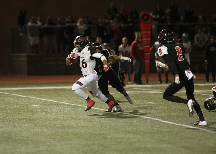 Bradshaw Mountain’s Anthony Mata (26) runs past two Coconino defenders on a 13-yard touchdown run in the second quarter Friday, Sept. 21, 2018, in Flagstaff. The Bears won 28-14. (Benji Shanahan/Arizona Daily Sun, Courtesy)