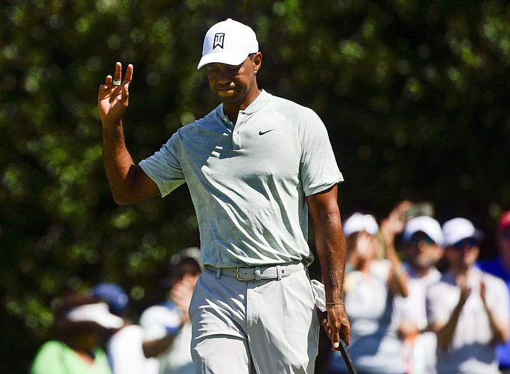 Tiger Woods acknowledges the gallery after making a birdie putt on the second green during the second round of the Tour Championship golf tournament Friday, Sept. 21, 2018, in Atlanta. (John Amis/AP)