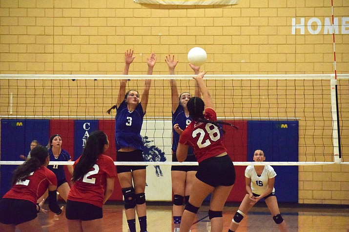 Camp Verde junior Kendall Peterson (3) and senior Rachel Stockseth (9) reach to block a Valley Lutheran spike during the Cowboys’ 3-1 loss at home on Tuesday night. VVN/James Kelley