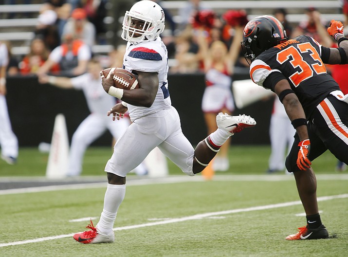Arizona running back J.J. Taylor looks back at Oregon State's Jalen Moore as he heads to the end zone on a 62 run in the fourth quarter of an NCAA college football game in Corvallis, Ore., Saturday, Sept 22, 2018. Arizona won 35-14. (Timothy J. Gonzalez/AP)

