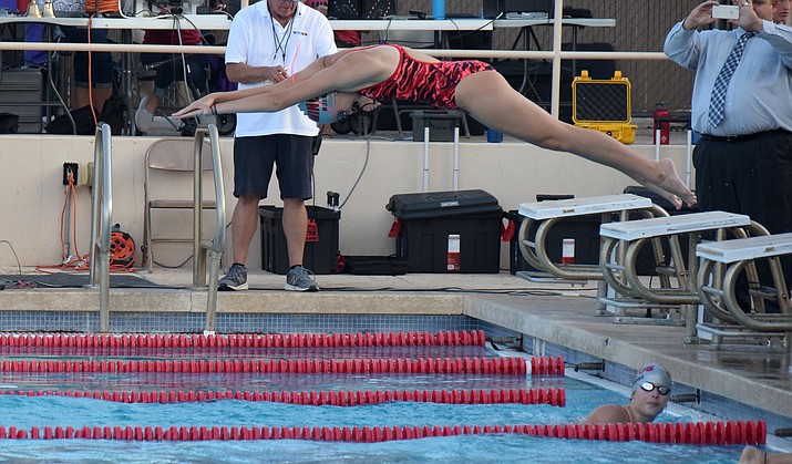Mingus senior Rylie Burke dives into the pool during a relay. Burke automatically qualified for state in the 50 and 100 freestyles. VVN/James Kelley