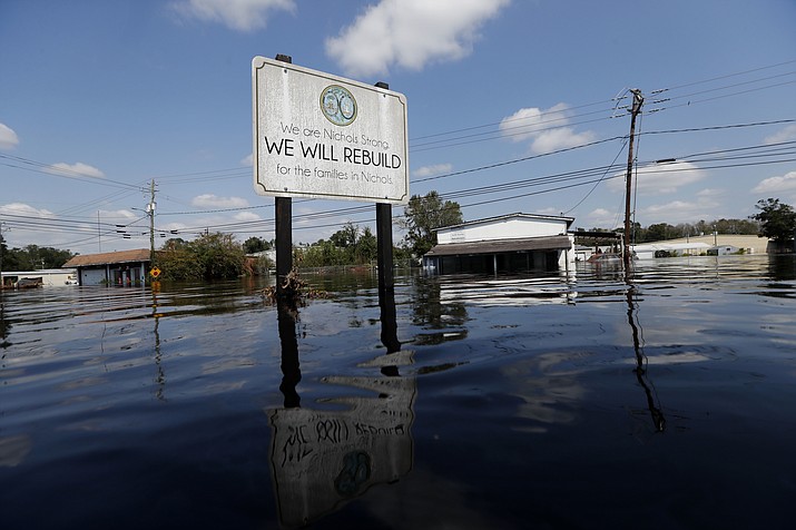 A sign commemorating the rebuilding of the town of Nichols, which was flooded two years earlier from Hurricane Matthew, stands in floodwaters in the aftermath of Hurricane Florence in Nichols, S.C., Friday, Sept. 21, 2018. Virtually the entire town is once again flooded and inaccessible except by boat. (Gerald Herbert/AP)

