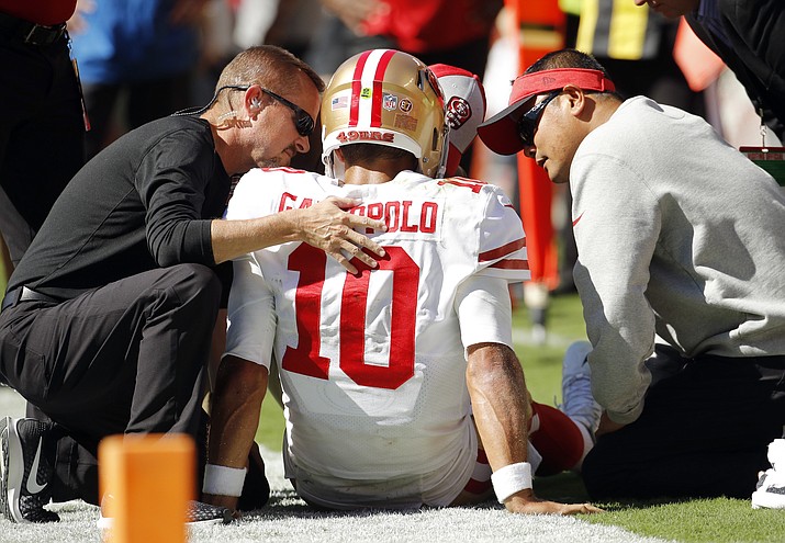 Trainers attend to San Francisco 49ers quarterback Jimmy Garoppolo (10) who was injured after a tackle by Kansas City Chiefs defensive back Steven Nelson during the second half of an NFL football game in Kansas City, Mo., Sunday, Sept. 23, 2018. (Charlie Riedel/AP)